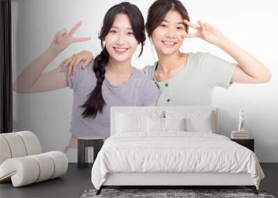 Two young beautiful smiling asian teenager female in summer clothes Wall mural