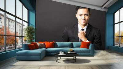 young asian businessman on black background Wall mural