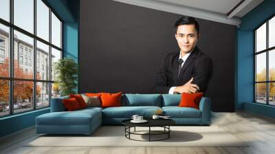 young asian businessman on black background Wall mural