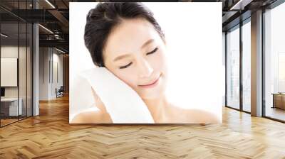 young woman cleaning her face with  towel Wall mural