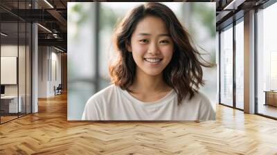 Young asian teenage girl smiling with plain white background  Wall mural