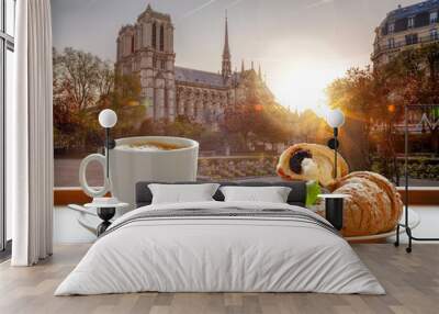 Coffee with croissants against cathedral Notre Dame in Paris, France Wall mural