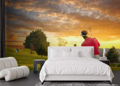 Man playing golf against colorful sunset Wall mural