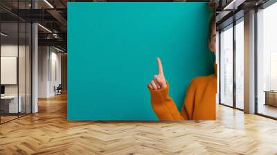 Woman pointing at an advertisement text on an green background, billboard concept Wall mural