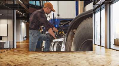 Caucasian Trucker Looking Inside Semi Truck Fuel Tank Wall mural