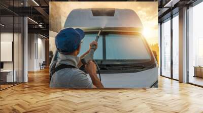 Men Pressure Washing His Camper Van RV During Scenic Sunset Wall mural