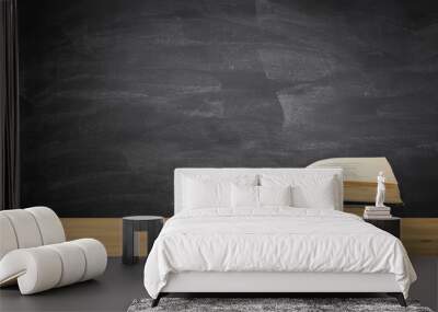 back to school concept. stack of books over wooden desk in front of blackboard. Wall mural