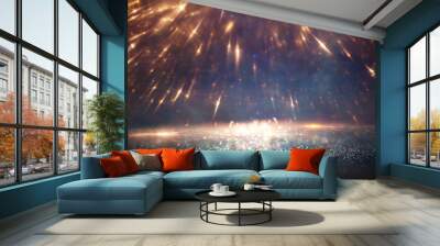 background of abstract glitter lights. gold, blue and black. de focused Wall mural