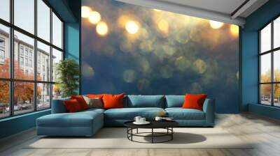 background of abstract glitter lights. gold, blue and black. de focused Wall mural