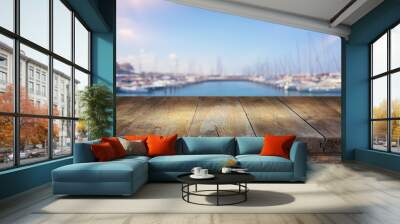 background of wood deck in front of blurred marina beach and sea with boates, yacht. ready for product display Wall mural