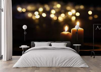 Burning candles over old wooden table with bokeh lights Wall mural