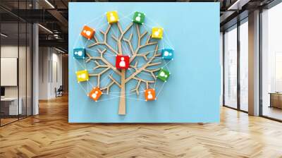 Business image of wooden tree with people icons over blue table, human resources and management concept Wall mural