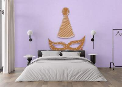 carnival party celebration concept with paper mask and clown hat over purple background. Top view. Flat lay Wall mural