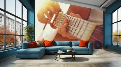 Close up of young girl playing acoustic guitar Wall mural