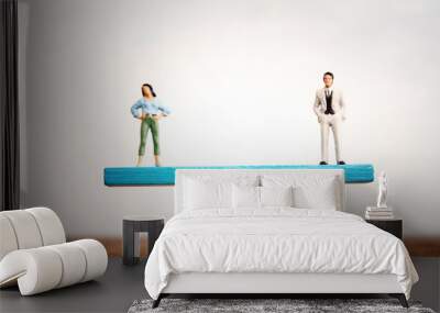 Concept image of gender equality. man and woman balancing on seesaw Wall mural