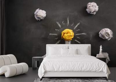 Education concept image. Creative idea and innovation. Crumpled paper as light bulb metaphor over blackboard Wall mural