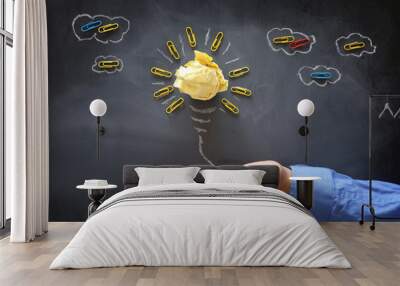 Education concept image. Creative idea and innovation. Crumpled paper as light bulb metaphor over blackboard Wall mural