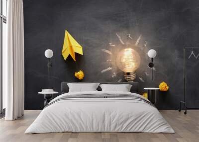 Education concept image. Creative idea and innovation. Light bulb as metaphor over blackboard Wall mural