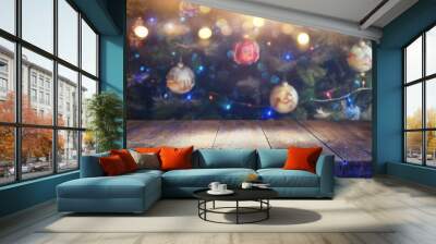 Empty table in front of christmas tree with decorations background. For product display montage. Wall mural