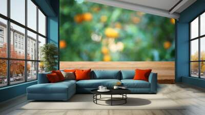 Empty wooden table in front of orange field Wall mural