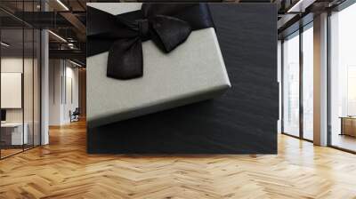 Grey gift box on dark textured background. Top view Wall mural