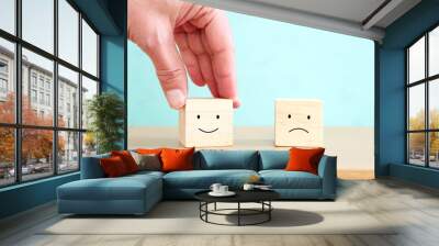 hand holding cube with happy face. concept of happiness emotion and satisfaction Wall mural