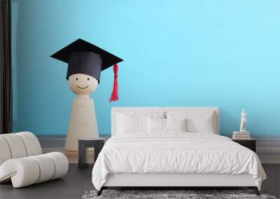 Image of education concept. Wooden people figure with graduation hat Wall mural