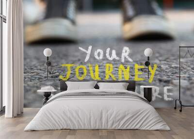 image with selective focus over asphalt road and person sneakers with handwritten text - your journey starts here.  education and motivation concept Wall mural