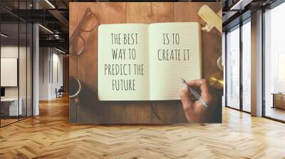 open notebook over wooden table with motivational saying Wall mural