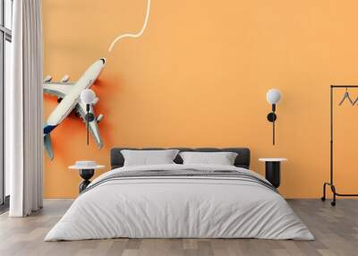 Top view of orange background and airplane. Concept of travel, vacation Wall mural