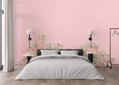 Top view of small white gypsophila flowers over pastel pink background Wall mural