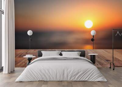 Wooden table and blurred sunset background. Summertime and vacation Wall mural