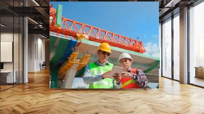 two Male Engineer using tablet computer at constructions site Wall mural