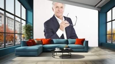 successful mature businessman looking at camera at work in offi Wall mural