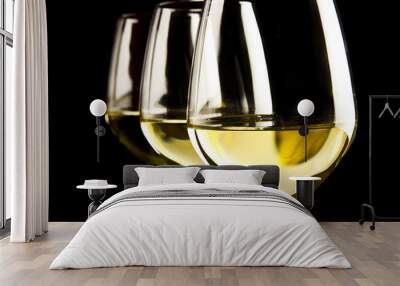 three glasses of white wine on black background Wall mural