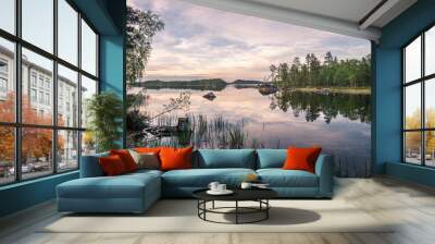 Panorama of calm lake at Lapland in midnight sun time. Rocks in front. Wall mural