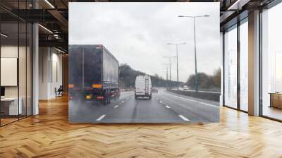 Transport cargo truck travelling down a busy road in rain the lorry has no logo Wall mural