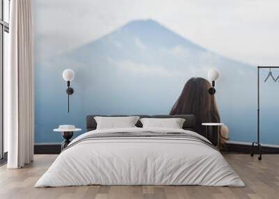 Girl looking at a cloudy mountain, Mount fuji, Japan Wall mural