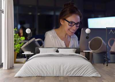 Super energetic businesswoman working late in office drinking too much caffeine Wall mural