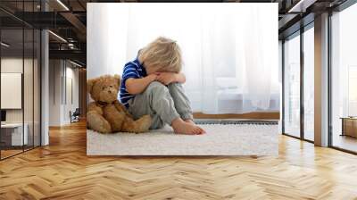 Child, toddler boy, punished in the corner for making mischieves Wall mural