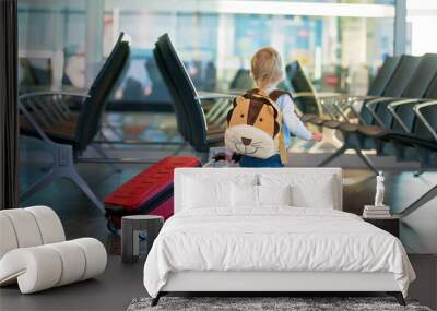 Children, traveling together, waiting at the airport to board the aircraft Wall mural