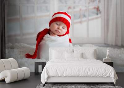 Christmas portrait of cute little newborn baby boy, wearing santa hat Wall mural