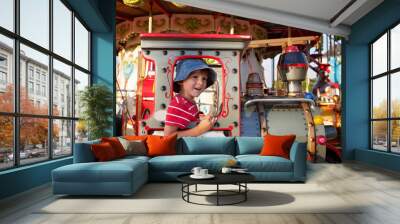 Sweet boy, riding in a train on a merry-go-round, carousel attra Wall mural