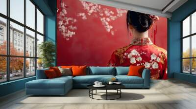 The girl in traditional Chinese dress, her outfit decorated with cherry blossom patterns, standing still with soft luster Wall mural