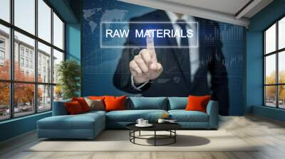 Businessman hand touching RAW MATERIALS  button on virtual scree Wall mural