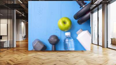 Fitness equipment and Health food on blue wooden background Wall mural