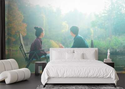 Happy traveler couple are enjoying with nature having coffee over lake in the morning , relaxation travel vacation concept.. Wall mural