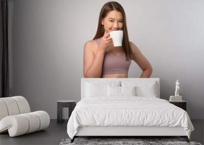 Portrait of asian fitness woman in sport wears over white background studio Wall mural