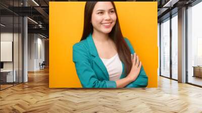 portrait of beautiful business woman in green suit on yellow background Wall mural