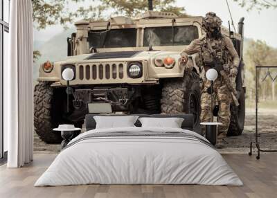 United States Army in camouflage uniforms operation in the forest.with armored vehicle, soldiers training  in a military operation Wall mural